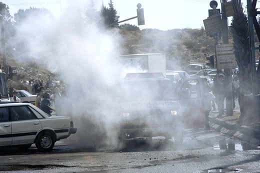 Picture for al-Ram Village - Palestine: : Occupation forces target a PRCS ambulance, firing tear gas through the rear window, which exploded inside.