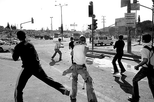 Picture for al-Ram Village - Palestine: : Young Palestinian men throw stones at Occupation forces.